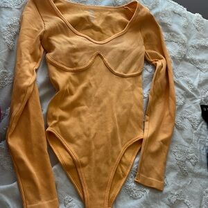 LIGHT ORANGE LONG SLEEVE ATHLETIC BODY SUIT SIZE SMALL NEVER WORN